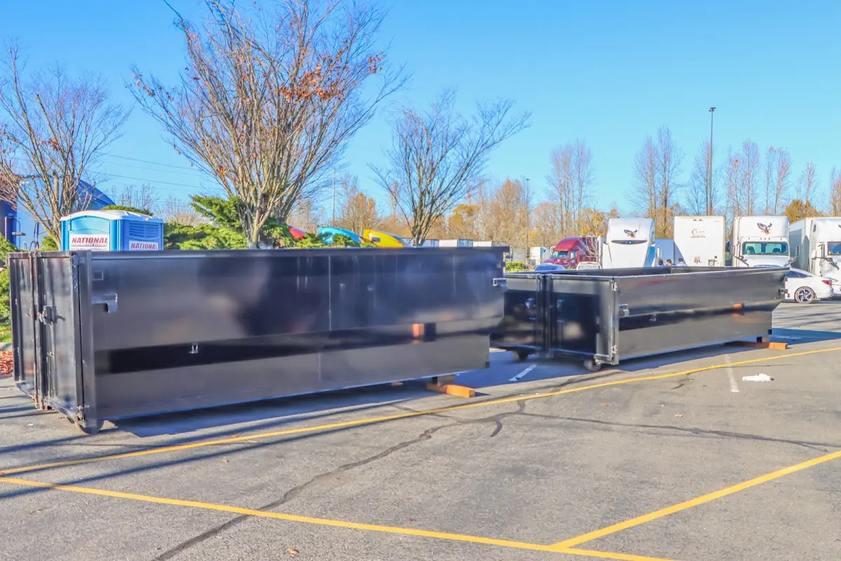 Professional dumpster rental service with roll-off container on residential driveway in Westfield